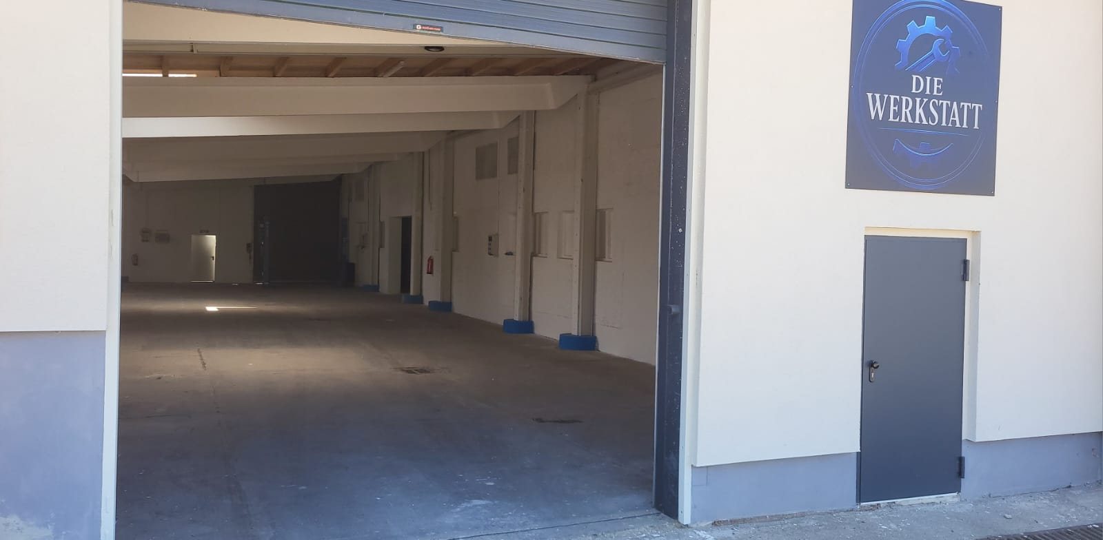 Einfahrt zur Werkstatt mit Werkstattschild